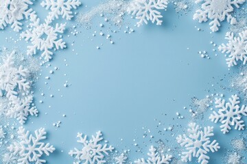 Clear white snowflakes on a baby blue background winter decoration outdoors.