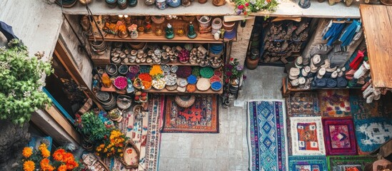 Overhead view of a vibrant shop filled with colorful rugs, pottery, and handcrafted goods.