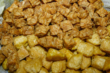 Fried tempeh and tofu on tissue paper absorbed oil