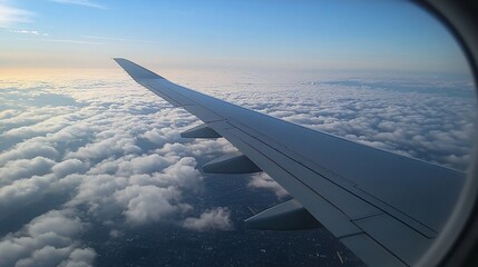 Fototapeta premium porthole, airplane wing, light clouds, sunny weather, travel