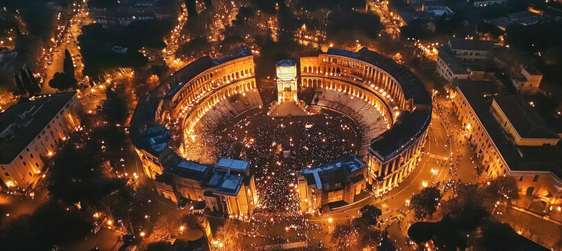 Crowd gathering in theatre of marcellus during night in rome, italy