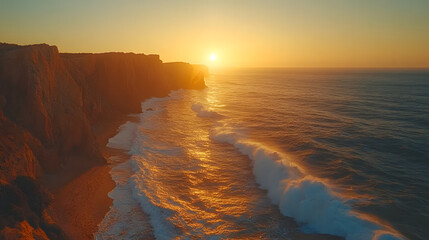 serene view of a golden sunset casting warm light on towering cliffs and ocean waves crashing along...