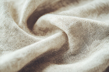 Light natural woven fabric displaying subtle texture and softness in a close-up view