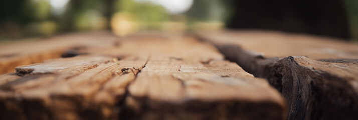 An intricate close-up view of an aged, weathered wooden surface displaying deep grooves and rich textures, conveying a sense of history and rustic charm.