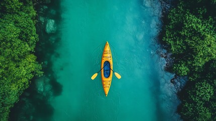 Aerial view of a single kayak on turquoise water surrounded by lush greenery.