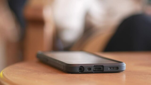 man hand picking up smart phone mobile to receive a call 