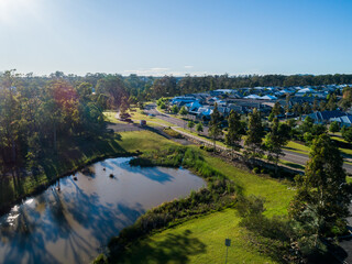 Dam in parkland and green strip between housing suburbs of Huntlee
