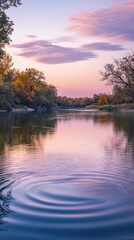Obraz premium A tranquil dusk view of the Kaw River reflecting autumn colors and gentle ripples on the surface