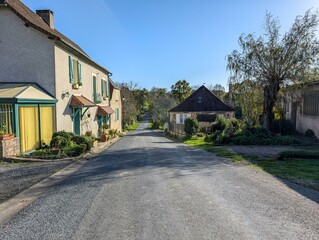 Quaint village street in Dordogne France under clear skies