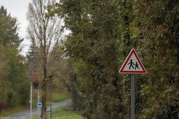 Road sign near forested path in Dordogne France countryside