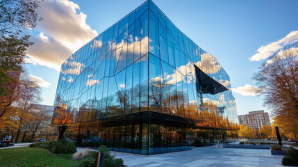 Fototapeta premium Close-up of a modern glass building reflecting the sky in clean, angular lines.