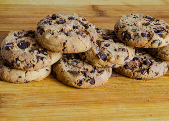 Chocolate chip cookies on a plate with a white background