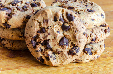 Chocolate chip cookies on a plate with a white background