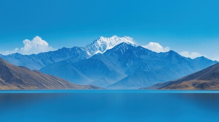 Majestic Mountain Range with Pristine Blue Lake and Clear Sky: A Serene Landscape of Nature's Beauty and Tranquility with Snow-Capped Peaks