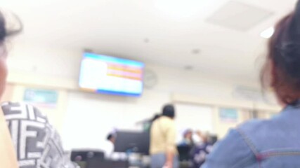 Footage blurred hospital. Blurred hospital interior, patients talking to nurses. Patients waiting to see a doctor, information center, reception and patient care. people and maintenance. Medical 