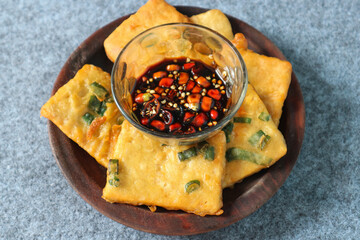 Tempe mendoan is a type of fried food from Indonesian with sweet soy sauce and sliced cayenne pepper
