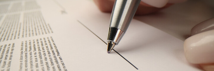 Businesswoman prepares to sign contract showing agreement