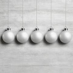 Five matte white Christmas ornaments hang in a row against a textured grey background.