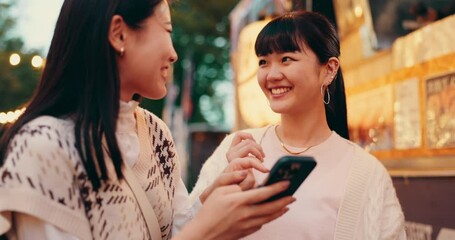 Laughing, friends and Japanese women with smartphone, city and funny videos on app, browsing and digital. Mobile, smile and bonding with gossip, social media and people on holiday, humor and Japan - Powered by Adobe