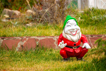 Ornaments in the garden, garden gnomes on the grass. Landscaping.