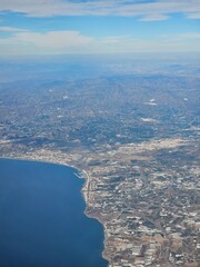 Spain, October 09, 2024: High flight in the mountains of the spanish coast. Aerial drone view to the cities, seaside and mountains. Beautiful landscape from the clouds.