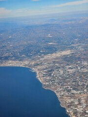 Spain, October 09, 2024: High flight in the mountains of the spanish coast. Aerial drone view to the cities, seaside and mountains. Beautiful landscape from the clouds.