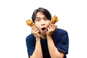 ecstatic young asian man wearing blue t-shirt holding fried crispy chicken thigh drumstick