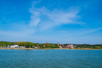 Fototapeta premium view on Krynica Morska resort with a ferris wheel as seen from a ferry on the Vistula Lagoon