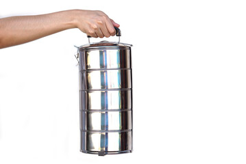 Hand holds  tiffin carrier stainless steel lunch box on white background. Concept, Reuse and...