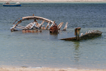 Partially submerged and disassembled boat