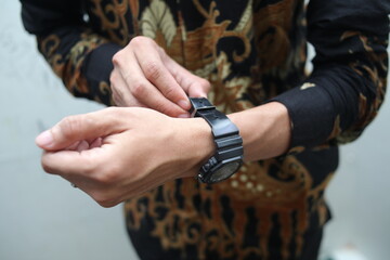 close up of a man's hand wearing a watch