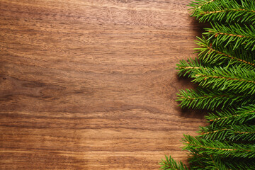 Chrismtas background top view with fir branches on wood background with copy space