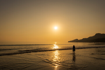 Silhouette of Girl Walking on Havelock Beach at Sunset
