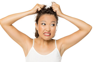 Beautiful nervous Asian girl with itch on her scalp on white background
