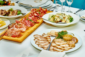 Festive delicious appetizers,snacks and salads on the banquet wedding table