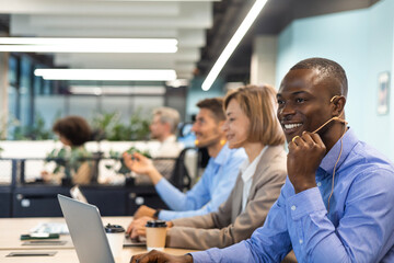 Obraz premium Attractive positive young businesspeople and colleagues in a call center office.