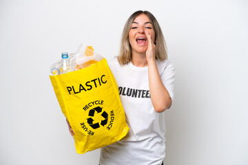 Young Rumanian woman holding a recycling bag full of plastic to recycle isolated on white...