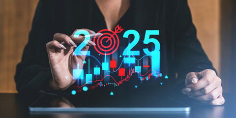 Businesswoman planning for 2025 with stock market charts and a target symbol in the background....