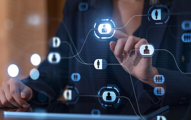 Businesswoman interacting with digital network interface on touchscreen device.