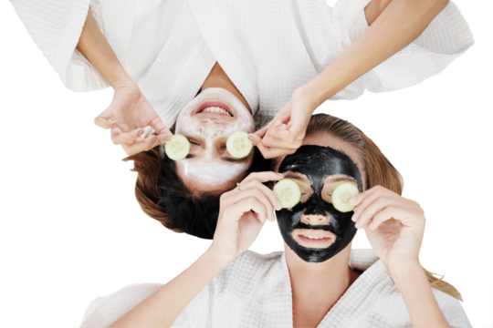Smiling Caucasian and Asian couple girls friends is holding sliced ​​cucumber and relaxing with facial masks clay for skin face care and lying down together for spa treatment clip art and element - Powered by Adobe
