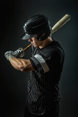 Young baseball player prepares to swing in a professional batting stance during practice