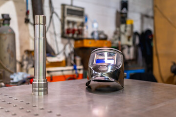 A welding helmet on a factory table