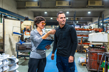 Female manager of factory talking to worker