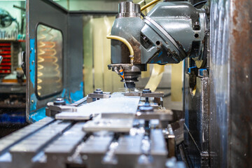 Milling machine shaping metal pieces in a factory