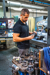 Technician working with milling machine in a cnc factory