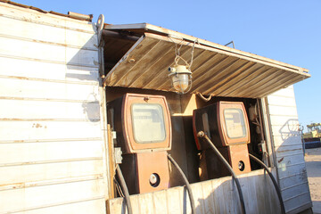 Vintage gas pumps at abandoned desert gas station, rustic nostalgia with retro fuel dispensers
