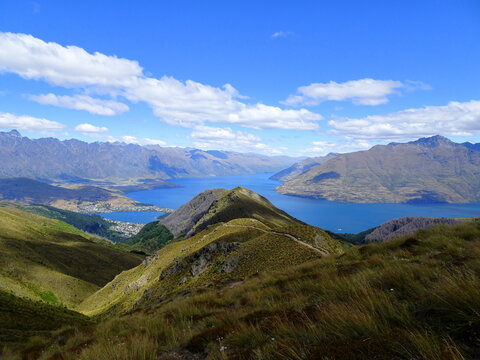 Above Queenstown,  famous hiking path to ben Lomond mountain. Scenic landscape with mountain ridges and lake wakatipu in summer. 