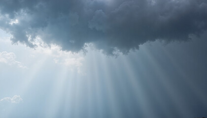 Fototapeta premium Dramatic cloudy sky with sun rays breaking through and copy space, Blue Monday theme