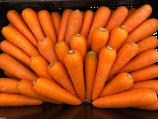 Carrots root for sale in basket on shelf 