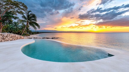 Fototapeta premium A swimming pool on the beach with a sunset in the background